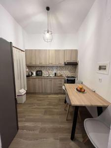 a kitchen with a table with a bowl of fruit on it at Almia Kotronas in Kotronas +17 photos