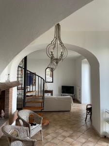 a living room with a couch and a chandelier at Villa San Vito Amalfi Coast a timeless charme in Vietri sul Mare