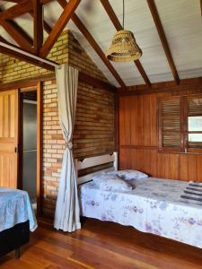 a bedroom with two beds and a ceiling at Encontro das Águas in Guarda do Embaú +17 photos