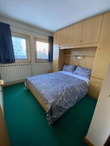 a bedroom with a bed with a built in headboard at Mountain View in Passo del Tonale