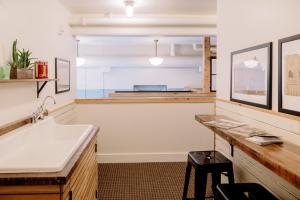 a kitchen with a sink and a counter top at The Society Hotel in Portland +76 photos