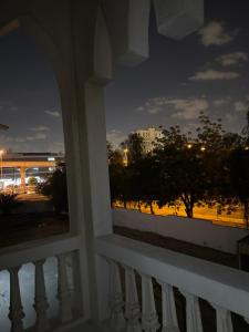 a view of a city from a balcony at night at Four Stars Residence in Dubai