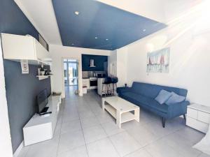a living room with a blue couch and a table at St Julians Penthouse in Paceville