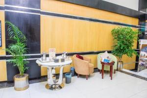 a table and chairs in front of a restaurant at Al Masem Luxury Hotel Suite 5 in Al Hofuf