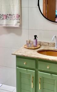 a bathroom with a green sink and a mirror at La Vita studio Lavanda in Nova Veneza +35 photos