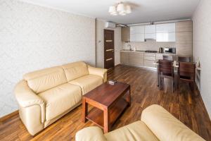 a living room with a couch and a table at OK Apartments Lviv in Lviv