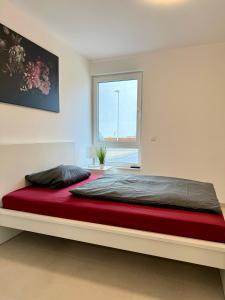 a large bed in a room with a window at Apartment WH6 in Frechen