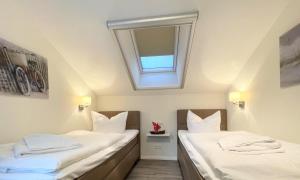 Ein Bett oder Betten in einem Zimmer der Unterkunft Strandvilla Baabe 10 HERZMUSCHEL