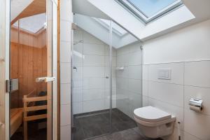 a bathroom with a toilet and a skylight at Casa Báltica Haffkrug in Haffkrug +13 photos