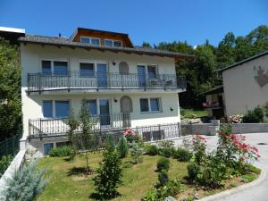 a house with a garden in front of it at Sobe apartma Milena in Bled +9 photos