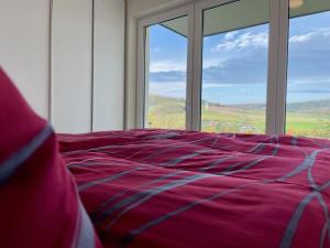 a bed in a room with a large window at Sonnenweg 18 in Heringhausen