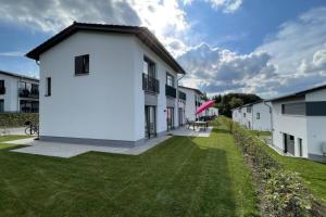a large white building with a grass yard at Sonnenweg 31 - HAUS DIEMELSEE in Heringhausen