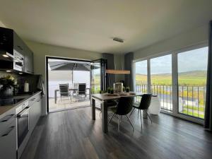 a kitchen with a table and chairs and a balcony at Sonnenweg 6 in Heringhausen