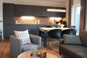 a kitchen and living room with a table and chairs at Sonnenweg 44-3 - HYGGE in Heringhausen