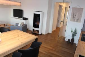 a living room with a table and a fireplace at Sonnenweg 44-3 - HYGGE in Heringhausen