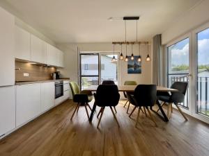 a kitchen and dining room with a table and chairs at Diemelblick 23 - DIEMELTJE in Heringhausen