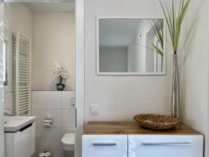 a bathroom with a toilet and a bowl on a counter at Diemelblick 23 - DIEMELTJE in Heringhausen +35 photos