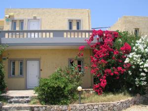 a house with pink flowers in front of it at Anthemis in Stavros