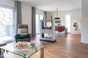 a living room with a fireplace and a table at Ferienhaus SONNENWEG 16 in Heringhausen