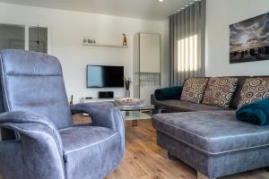 a living room with a couch and a chair at Ferienhaus SONNENWEG 16 in Heringhausen
