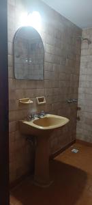 a bathroom with a sink and a mirror at El nuevo amanecer mar de ajó in Mar de Ajó