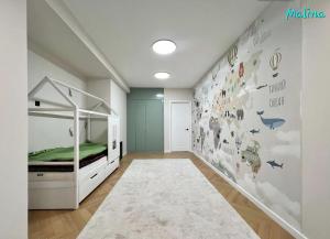 a bedroom with a bed and a wall with animals at 3 Bedroom Apartment Malina Residence in Bishkek