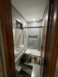 a bathroom with two sinks and a toilet and a shower at Encanto da Barra Pousada in Barra Grande