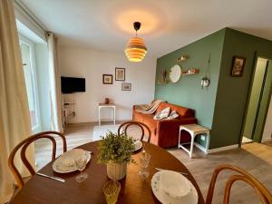 a living room with a table with chairs and a couch at La Grange - Ground Floor Apartment, Terrace, Free Private Parking, Near Colmar in Sainte-Croix-en-Plaine