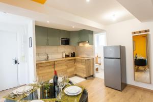 a kitchen with a table with wine glasses on it at La promesse - T2 Hyper centre in Abbeville
