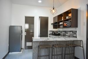 a kitchen with a counter and a refrigerator at Casa Bugambilia Door 2 in Balamban +10 photos