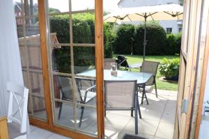 a patio with a table and chairs and an umbrella at Appartement 5 in Scharbeutz