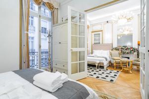 a bedroom with a bed and a living room at Paix in Paris