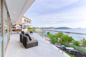 a balcony of a house with a view of the water at Villa W Collection in Nai Harn Beach