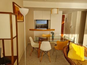 a dining room with a glass table and chairs at San Alfonso del Mar Departamentos in Algarrobo