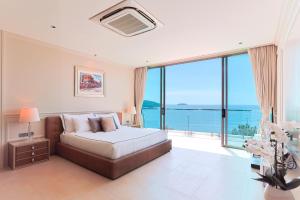 a bedroom with a bed with a view of the ocean at Villa W Collection in Nai Harn Beach +46 photos