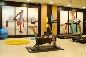 a gym with a treadmill and a exercise bike at Kairos Garda Hotel in Castelnuovo del Garda