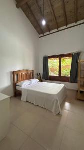 a bedroom with a bed and a window in it at Casa das Alpinias - Trancoso in Trancoso +20 photos