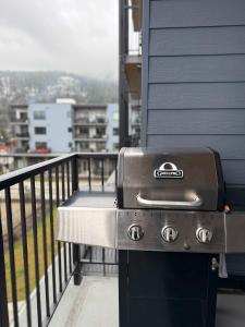 a grill sitting on the side of a balcony at Revelstoke Marvel - Two Bedroom with Hot Tub in Revelstoke