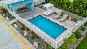 an overhead view of a swimming pool with a white fence around it at Affordable Luxury Apartments, 3 Min to Beach in West Bay