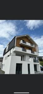 a large white building with at Marmotta Paltinis in Păltiniş