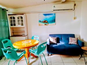 a living room with a table and a blue couch at Lorna's Cottage in Crown Point