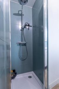 a shower with a glass door in a bathroom at Au coeur de Marlotte in Bourron-Marlotte