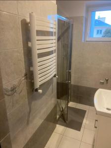 a bathroom with a shower and a sink at Apartament Mączyńskiego in Jarosław