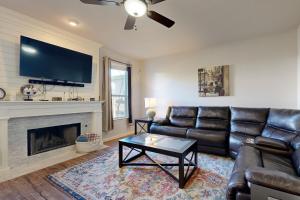 a living room with a couch and a fireplace at Living the Dream in San Antonio
