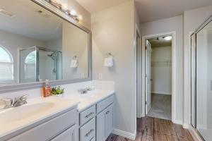 a bathroom with two sinks and a large mirror at Living the Dream in San Antonio +18 photos