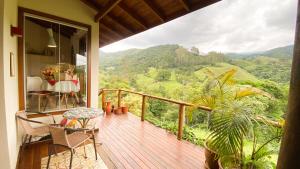 a balcony of a house with a view of the mountains at Chalé nas montanhas em São Francisco Xavier in São Francisco Xavier