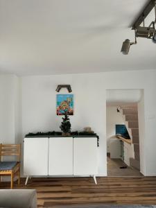 a living room with white cabinets and a table at Táltos in Szentendre