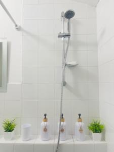 a bathroom with a shower with plants in it at Cozy Urban Scape in London