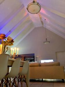 a dining room with a table and a couch at #SilverSands Coastal Retreat in Betty's Bay in Bettyʼs Bay