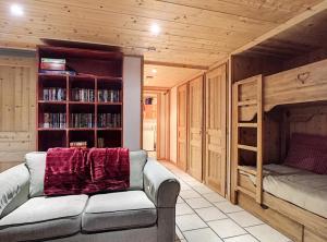 a living room with a couch and a bunk bed at Chalet Le Renard Du Lac in Les Gets
